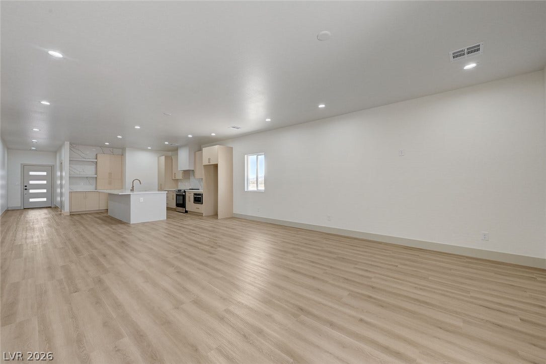 Clean lines and smooth flooring define this spacious, modern open-concept layout.