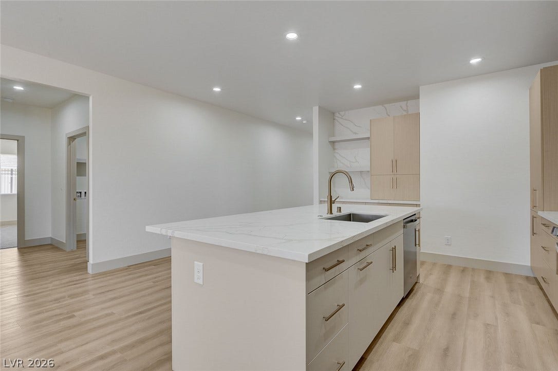 Clean lines and a spacious center island define this modern culinary workspace.