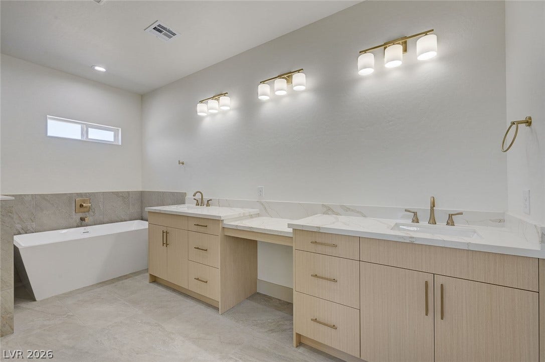 Clean lines and a spacious dual vanity highlight this contemporary primary bathroom retreat.