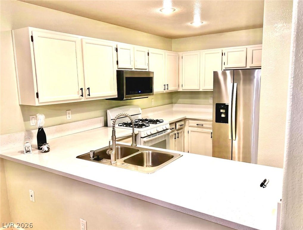7950 W Flamingo Road, #1128, Las Vegas, NV 89147 Bright countertops pair beautifully with white cabinetry and modern stainless steel appliances.