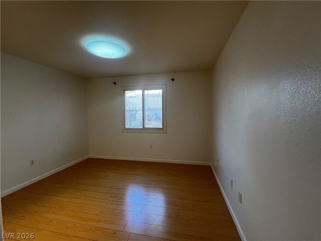 7950 W Flamingo Road, #1128, Las Vegas, NV 89147 Gleaming hardwood floors and a central window define this versatile bedroom space.