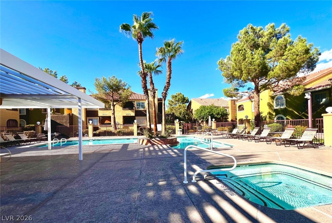 7950 W Flamingo Road, #1128, Las Vegas, NV 89147 A sparkling community pool and spa area is surrounded by palms and neat paving.