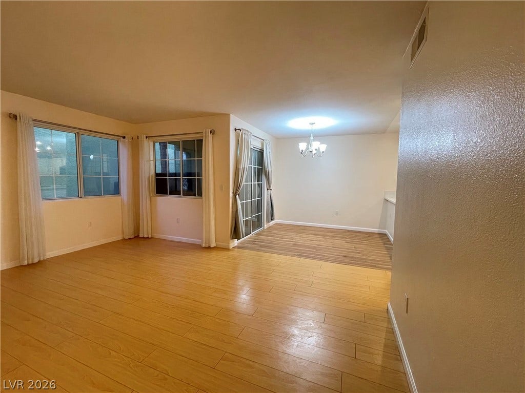 7950 W Flamingo Road, #1128, Las Vegas, NV 89147 Gleaming wood floors anchor an airy, open layout flowing seamlessly toward the dining area.