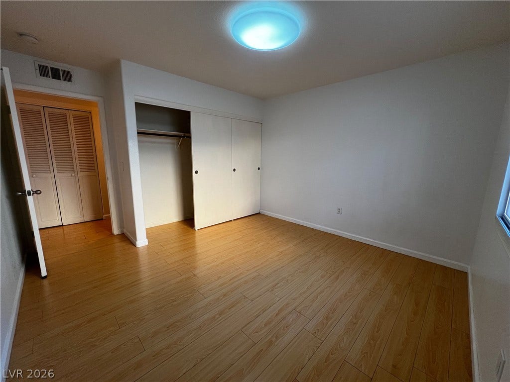 7950 W Flamingo Road, #1128, Las Vegas, NV 89147 Warm wood-look flooring sets a welcoming tone in this versatile bedroom.