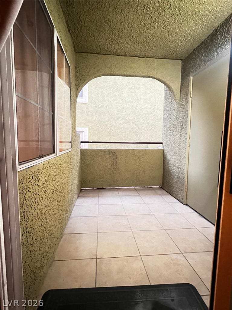 7950 W Flamingo Road, #1128, Las Vegas, NV 89147 A private covered balcony features durable tile flooring and textured stucco walls.