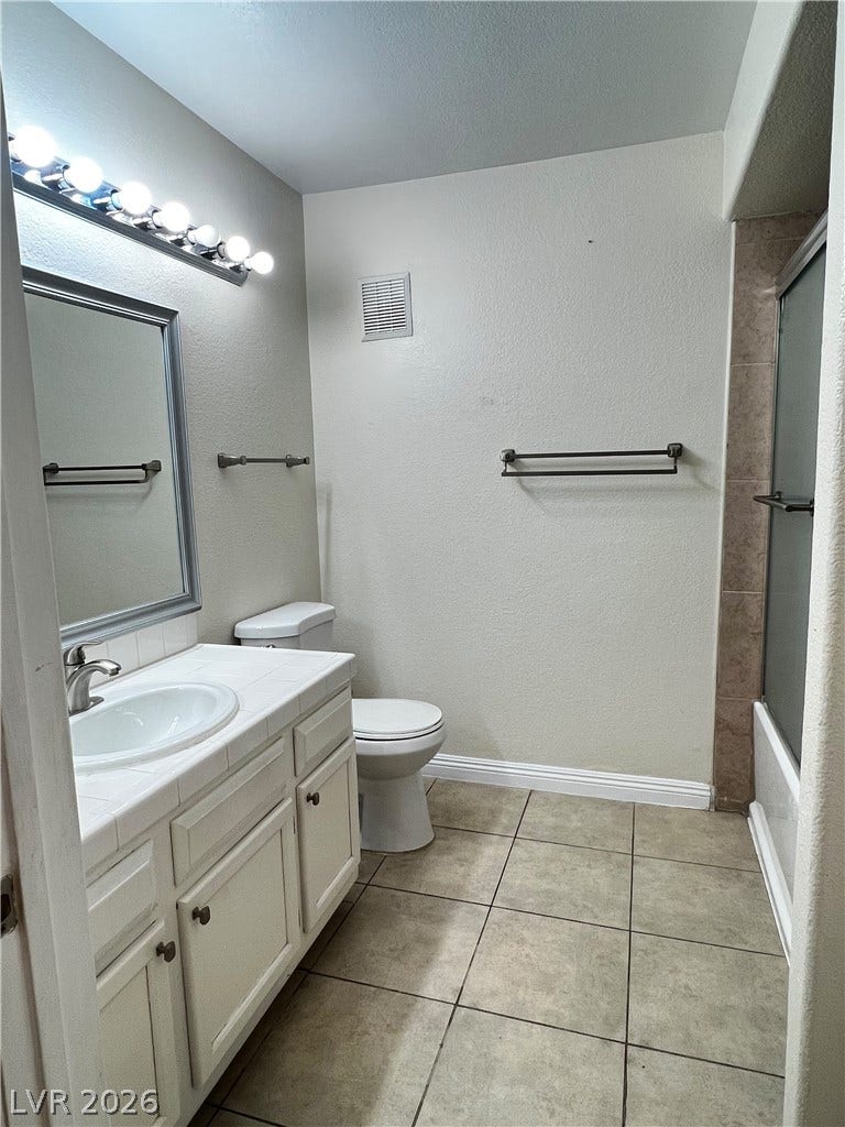7950 W Flamingo Road, #1128, Las Vegas, NV 89147 A classic tiled vanity pairs perfectly with durable flooring and a shower-tub combination.