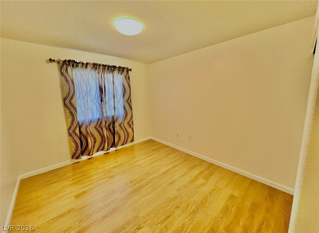7950 W Flamingo Road, #1128, Las Vegas, NV 89147 Smooth wood floors and neutral walls define this versatile bedroom space.