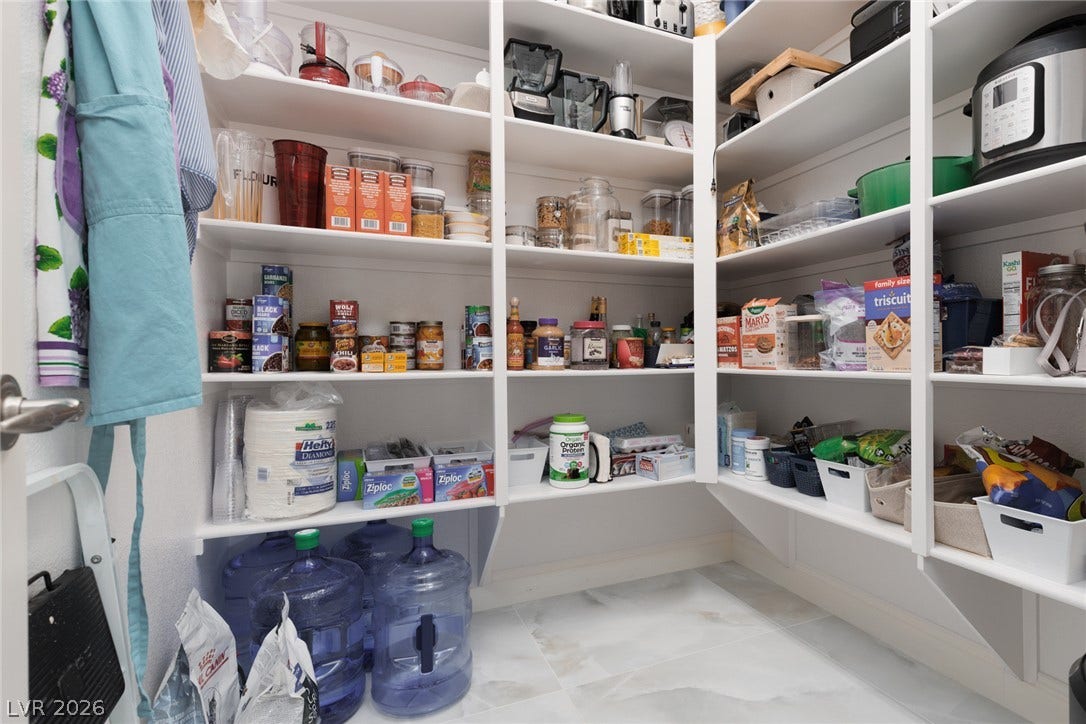 9795 Amador Ranch Avenue, Las Vegas, NV 89149 Ample built-in shelving maximizes storage potential in this walk-in pantry.