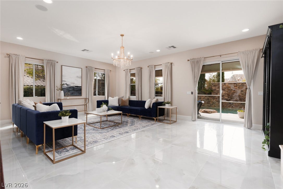 9795 Amador Ranch Avenue, Las Vegas, NV 89149 Gleaming polished tile floors and high ceilings elevate this open, light-filled living area.