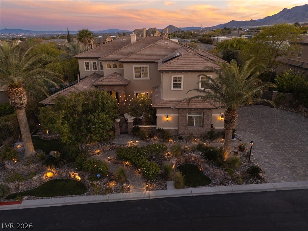 9795 Amador Ranch Avenue, Las Vegas, NV 89149 An elegant tile roof, stone accents, and manicured desert landscaping define this grand multi-level exterior.