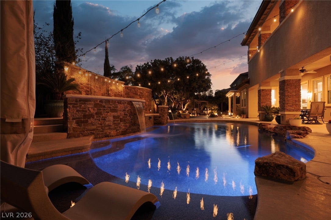 9795 Amador Ranch Avenue, Las Vegas, NV 89149 An inviting backyard oasis features a custom swimming pool with integrated stone waterfalls.