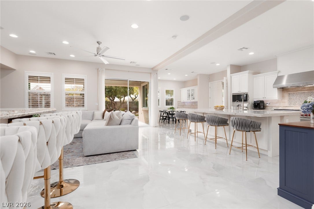 9795 Amador Ranch Avenue, Las Vegas, NV 89149 Gleaming polished tile floors span this open concept living space integrating the kitchen and family room.