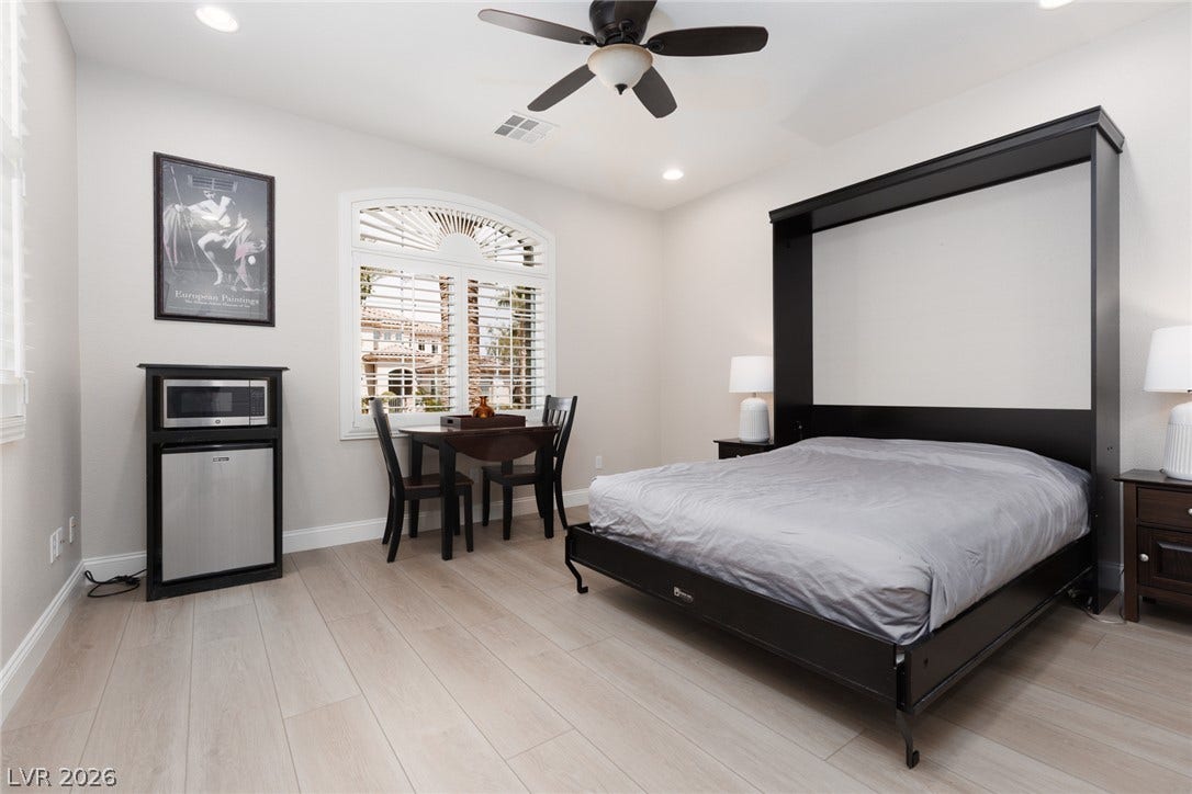 9795 Amador Ranch Avenue, Las Vegas, NV 89149 Streamlined wood flooring paired with a classic arched window highlights this versatile room.