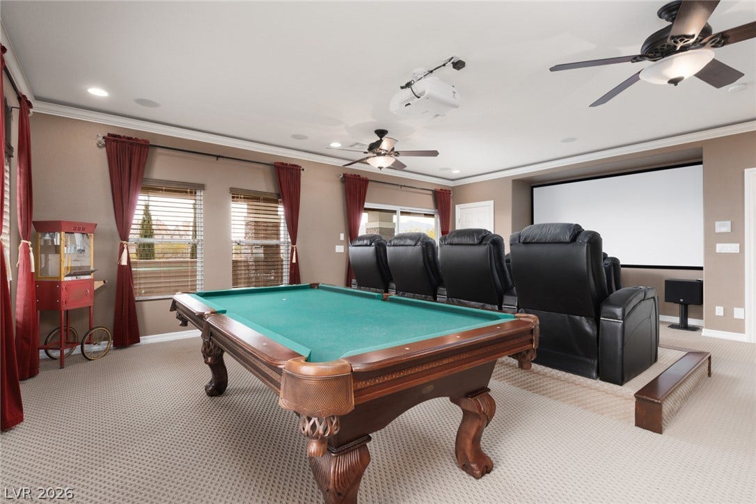 9795 Amador Ranch Avenue, Las Vegas, NV 89149 An expansive recreation room offers plush carpeting, crown molding, and recessed lighting throughout.