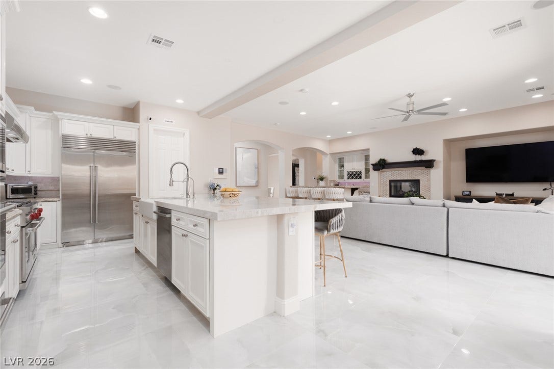 9795 Amador Ranch Avenue, Las Vegas, NV 89149 Polished tile flooring flows seamlessly through this open-concept kitchen and living space.