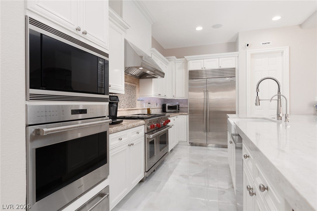 9795 Amador Ranch Avenue, Las Vegas, NV 89149 Polished tile flooring and professional-grade appliances anchor this well-appointed gourmet kitchen.