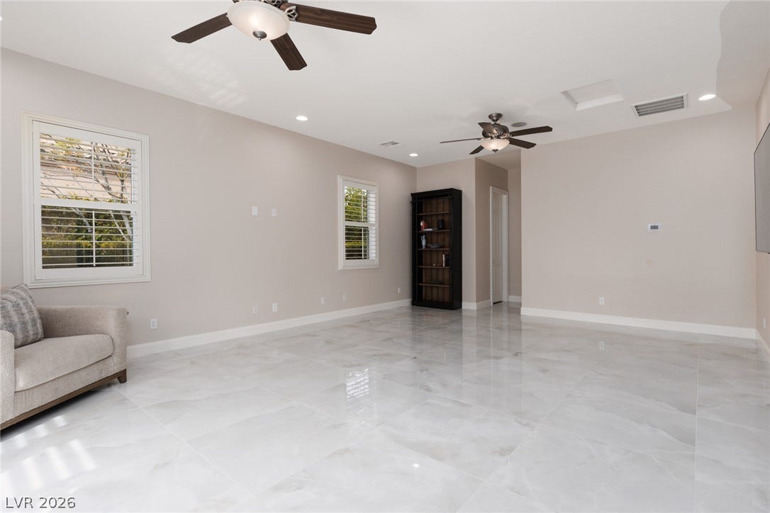 9795 Amador Ranch Avenue, Las Vegas, NV 89149 Gleaming tile floors and recessed lighting enhance this airy, versatile living area.