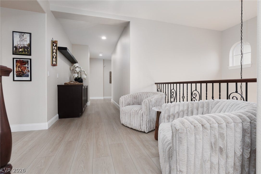9795 Amador Ranch Avenue, Las Vegas, NV 89149 Smooth wood floors and crisp white walls create a clean upper-level hallway landing.