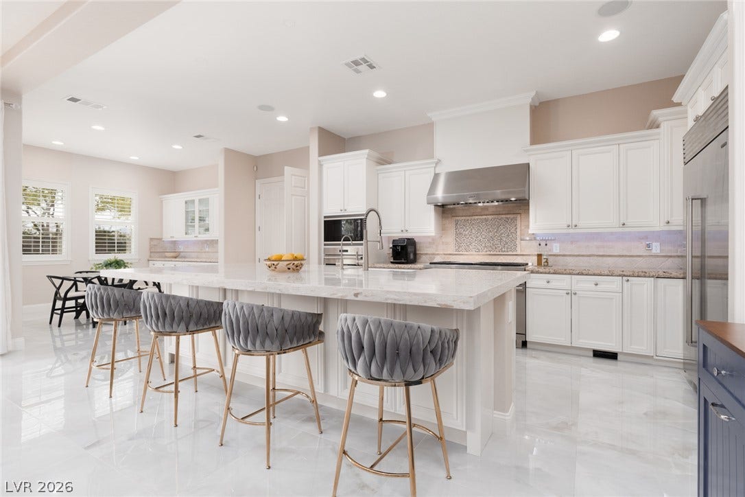 9795 Amador Ranch Avenue, Las Vegas, NV 89149 Gleaming stone tile flooring and a massive center island define this gourmet culinary space.
