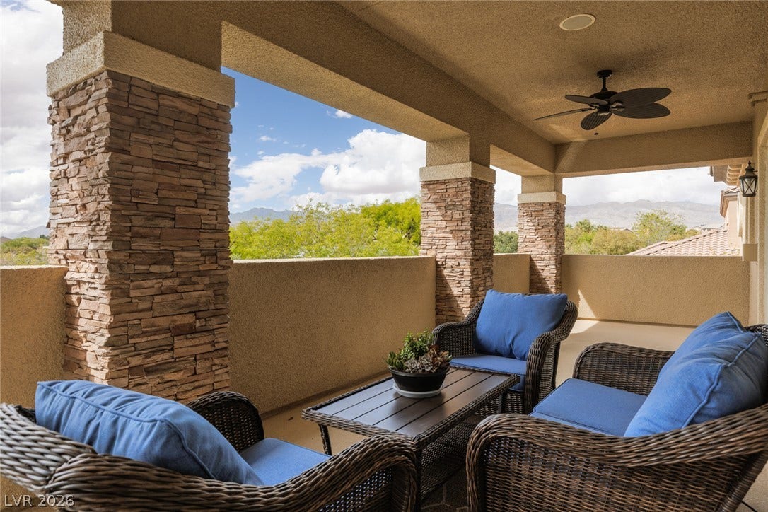 9795 Amador Ranch Avenue, Las Vegas, NV 89149 Shaded outdoor living spaces framed by stone pillars look out over scenic mountain vistas.
