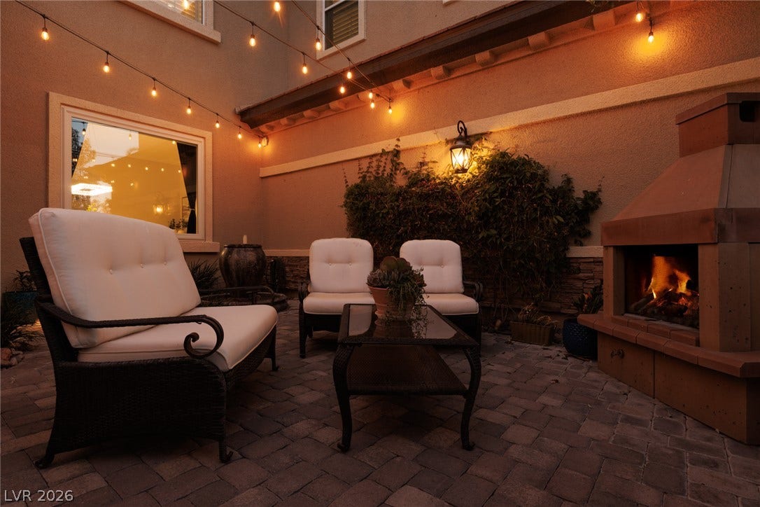 9795 Amador Ranch Avenue, Las Vegas, NV 89149 An inviting stone paver courtyard anchors this outdoor living space with a warm fireplace.