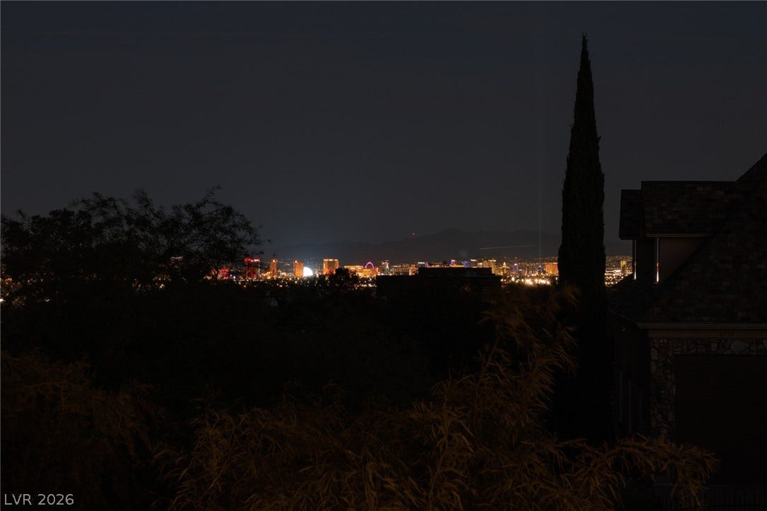 9795 Amador Ranch Avenue, Las Vegas, NV 89149 Glittering city lights sparkle across the horizon under a dark night sky.