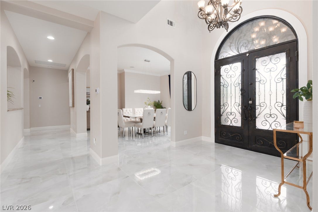 9795 Amador Ranch Avenue, Las Vegas, NV 89149 Gleaming polished tile floors guide guests from the grand arched double-door entryway.