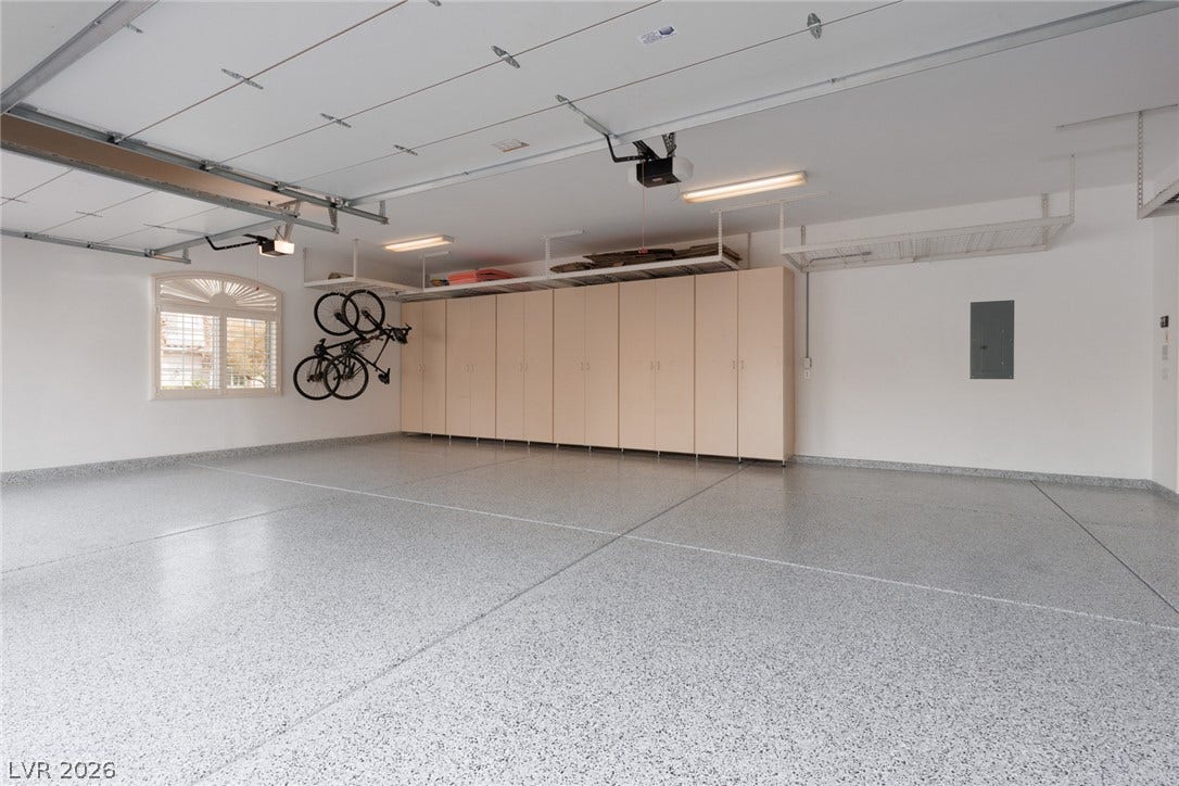 9795 Amador Ranch Avenue, Las Vegas, NV 89149 A spacious garage features durable epoxy flooring and extensive built-in storage cabinets.