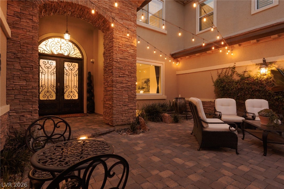 9795 Amador Ranch Avenue, Las Vegas, NV 89149 A stone archway and brick pavers define this inviting entryway courtyard.