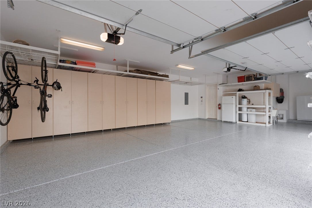 9795 Amador Ranch Avenue, Las Vegas, NV 89149 An organized multi-car garage provides extensive built-in storage cabinets and a durable epoxy-coated floor.