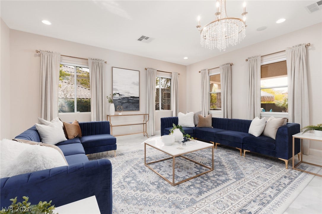 9795 Amador Ranch Avenue, Las Vegas, NV 89149 Recessed lighting and a classic crystal chandelier illuminate this polished tile living space.