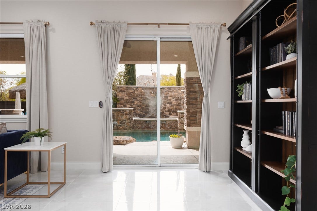 9795 Amador Ranch Avenue, Las Vegas, NV 89149 Gleaming tile floors reflect light pouring in through sliding doors that open to the pool.