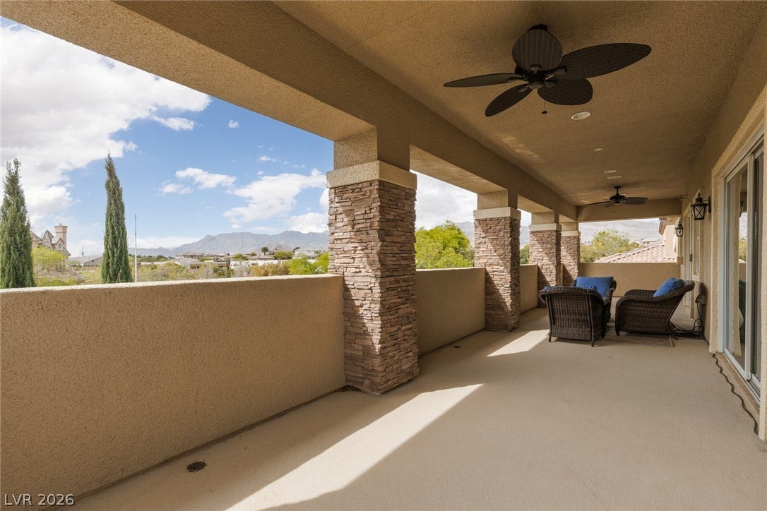 9795 Amador Ranch Avenue, Las Vegas, NV 89149 Stone pillars and concrete flooring line this covered outdoor balcony overlooking mountain views.
