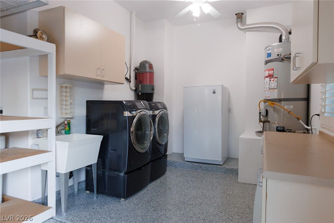 9795 Amador Ranch Avenue, Las Vegas, NV 89149 Functional utility space with built-in cabinetry, durable epoxy flooring, and structured laundry organization.