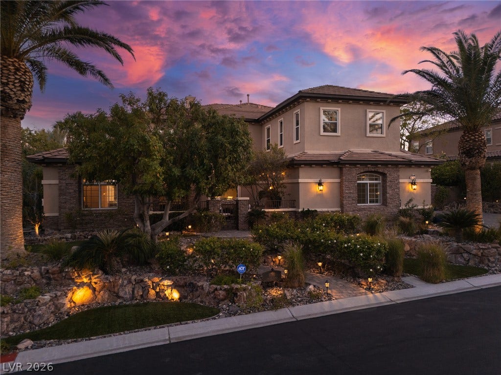 9795 Amador Ranch Avenue, Las Vegas, NV 89149 Lush tropical landscaping and stone masonry elevate the curb appeal of this multi-level custom residence.
