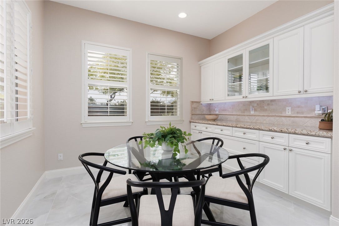 9795 Amador Ranch Avenue, Las Vegas, NV 89149 An elegant dining space features built-in cabinetry, granite counters, and classic plantation shutters.