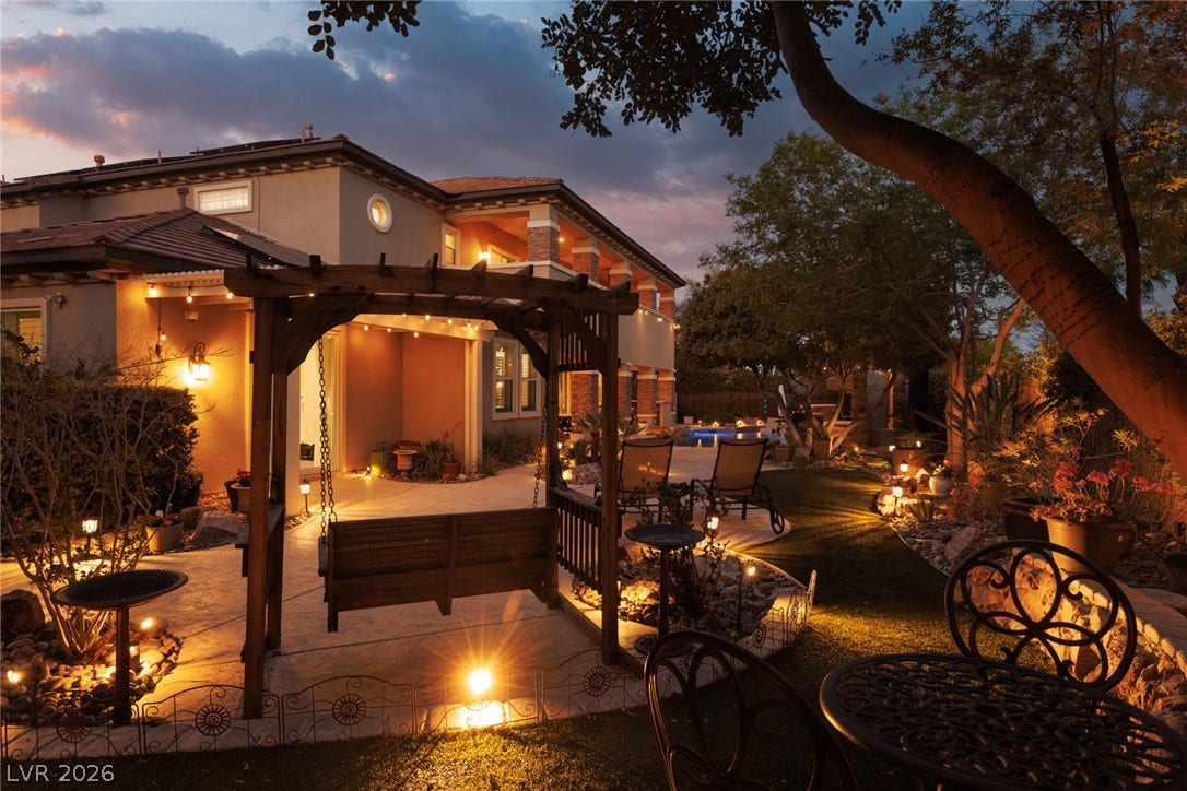 9795 Amador Ranch Avenue, Las Vegas, NV 89149 Lushly landscaped grounds offer a serene escape with custom lighting and architectural detail.