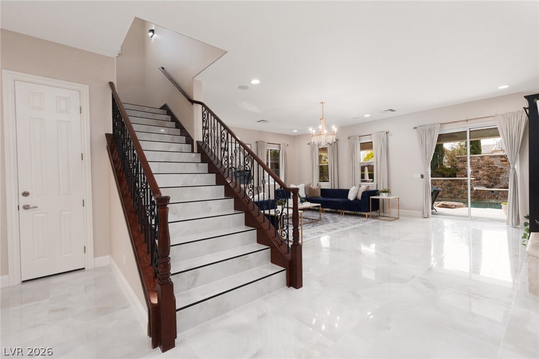 9795 Amador Ranch Avenue, Las Vegas, NV 89149 Polished tile flooring and an elegant staircase highlight this open living area.