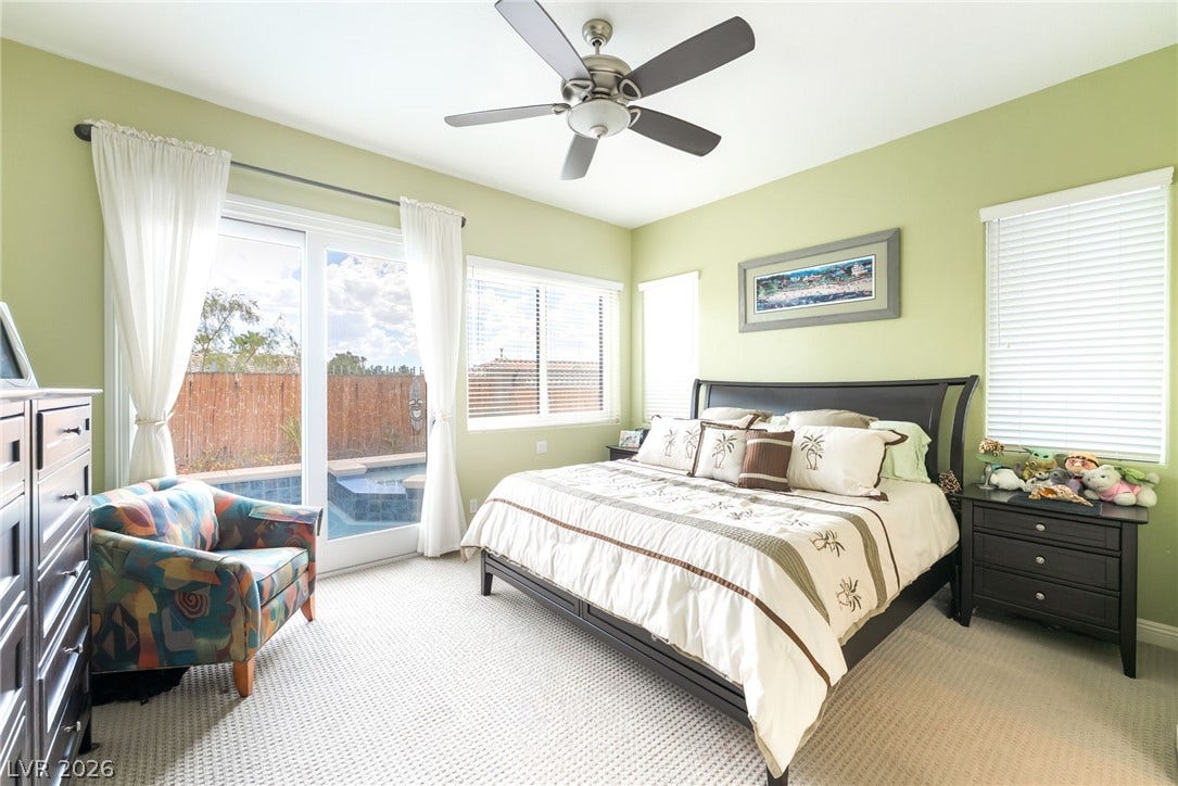 3033 Via Meridiana, Henderson, NV 89052 Sliding glass doors offer seamless transition from this comfortable bedroom to the pool patio.