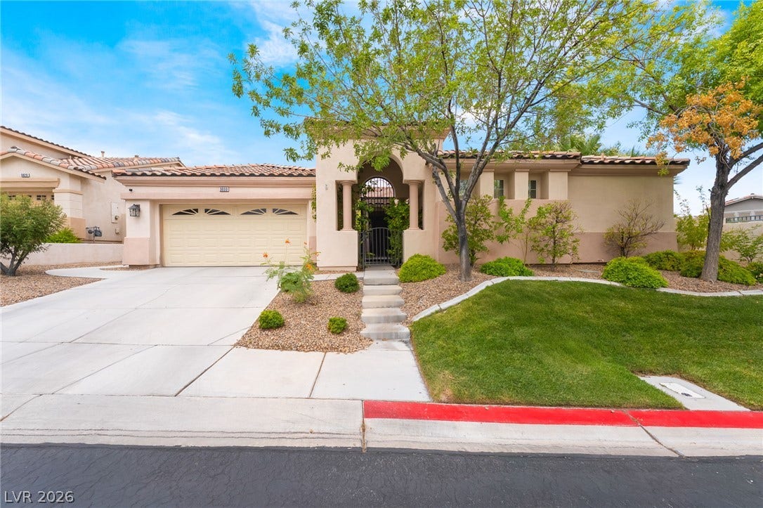 3033 Via Meridiana, Henderson, NV 89052 Stucco arches and Spanish tile roofs define this Mediterranean-style exterior design.