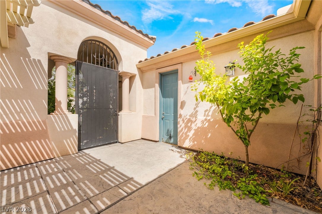 3033 Via Meridiana, Henderson, NV 89052 Sunlight filters through a classic pergola onto this private, gated entry courtyard.