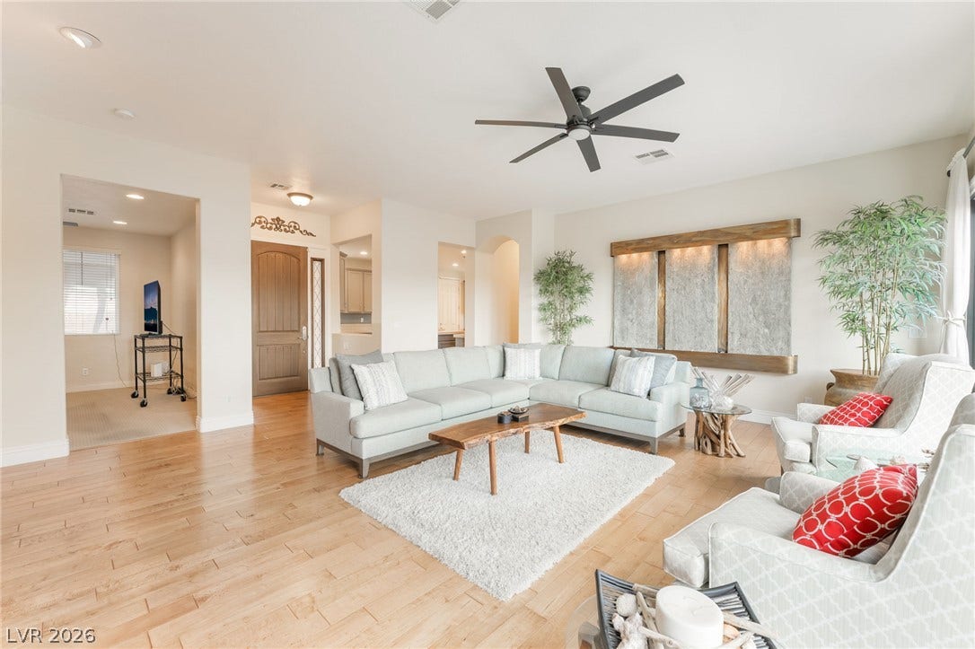 3033 Via Meridiana, Henderson, NV 89052 Gleaming hardwood floors and a spacious open layout define this inviting living area.