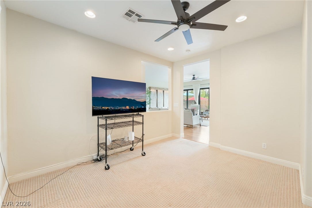 3033 Via Meridiana, Henderson, NV 89052 Textured neutral carpeting, high ceilings, and recessed lighting create a comfortable living environment.