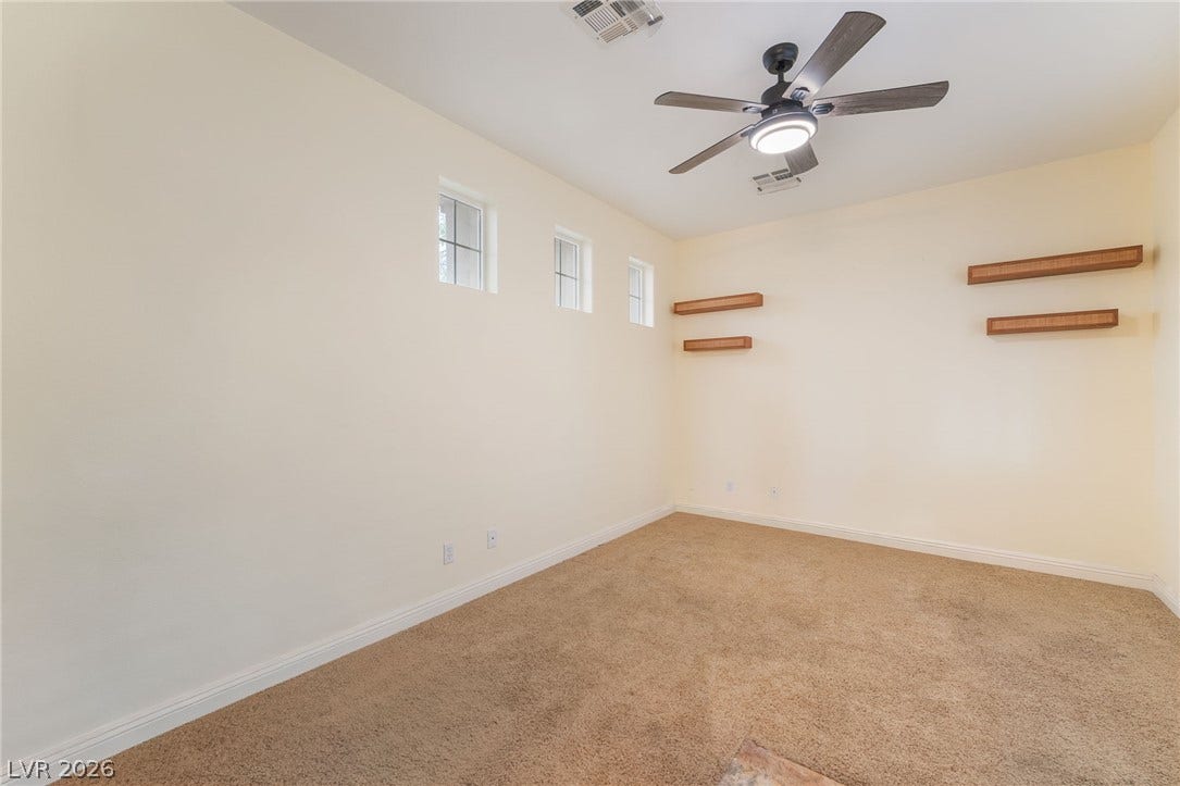 3033 Via Meridiana, Henderson, NV 89052 High clerestory windows and soft carpeting create a peaceful atmosphere in this versatile bedroom.