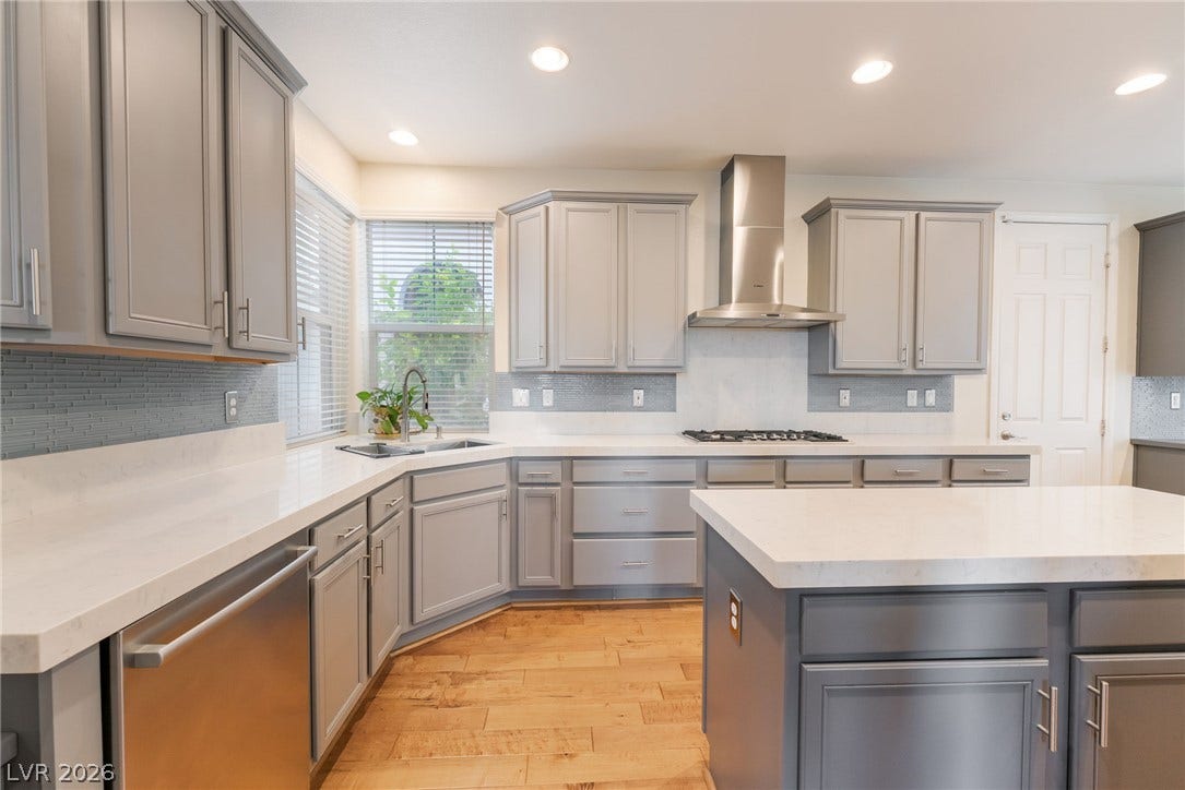 3033 Via Meridiana, Henderson, NV 89052 Gleaming stone countertops and matching cabinetry surround a spacious center island.