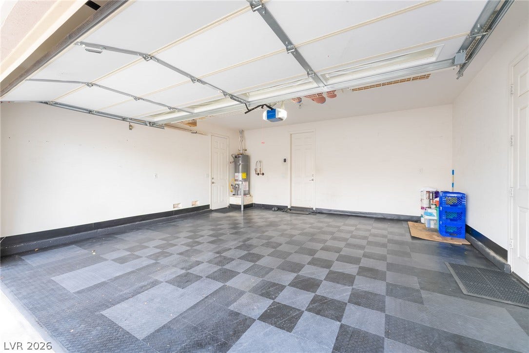 3033 Via Meridiana, Henderson, NV 89052 A spacious garage showcases checkerboard flooring and an automatic overhead door.