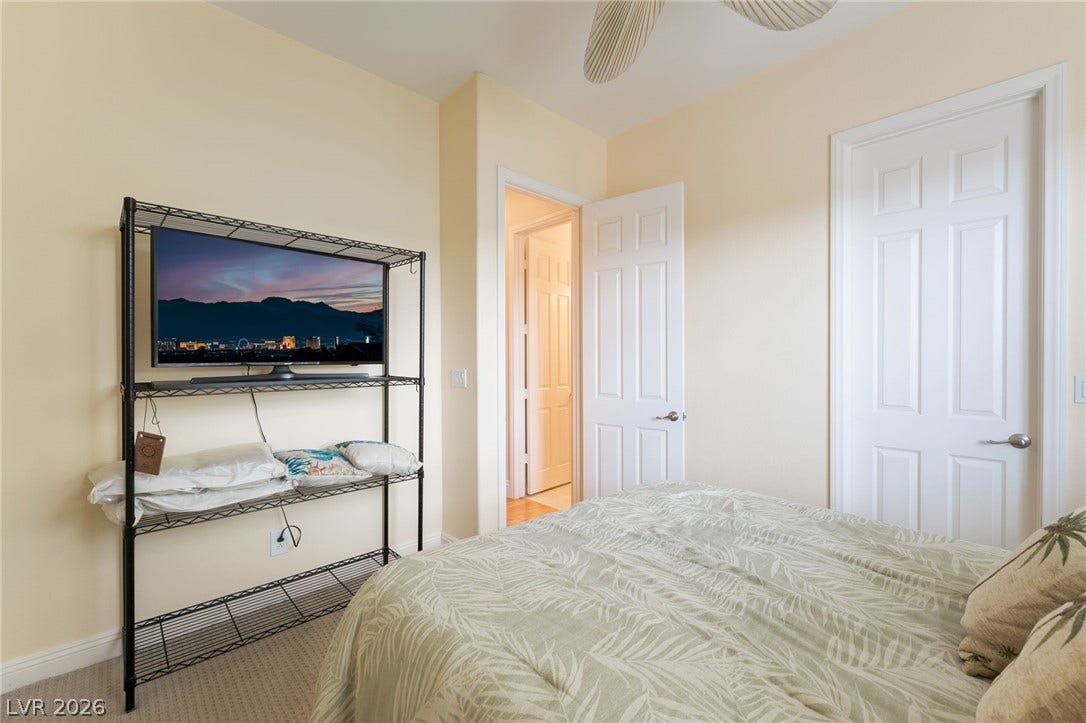 3033 Via Meridiana, Henderson, NV 89052 Plush carpeting and classic six-panel doors define this comfortable guest bedroom space.