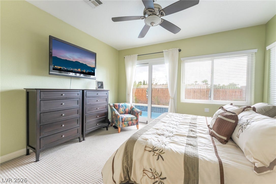 3033 Via Meridiana, Henderson, NV 89052 Sliding glass doors offer seamless access from the bedroom to the private pool area.