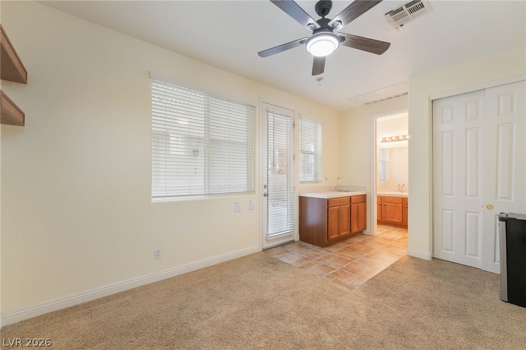 3033 Via Meridiana, Henderson, NV 89052 Plentiful natural light fills a versatile living space featuring a convenient wet bar.