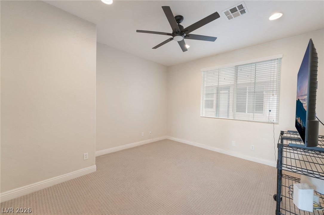 3033 Via Meridiana, Henderson, NV 89052 Recessed lighting and soft carpeting create a comfortable atmosphere in this versatile space.